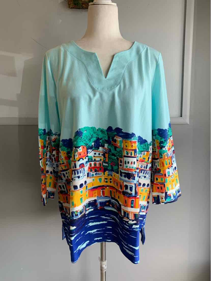 Light blue blouse with colorful cityscape print along hem and sleeves, three-quarter sleeves, V-neckline.