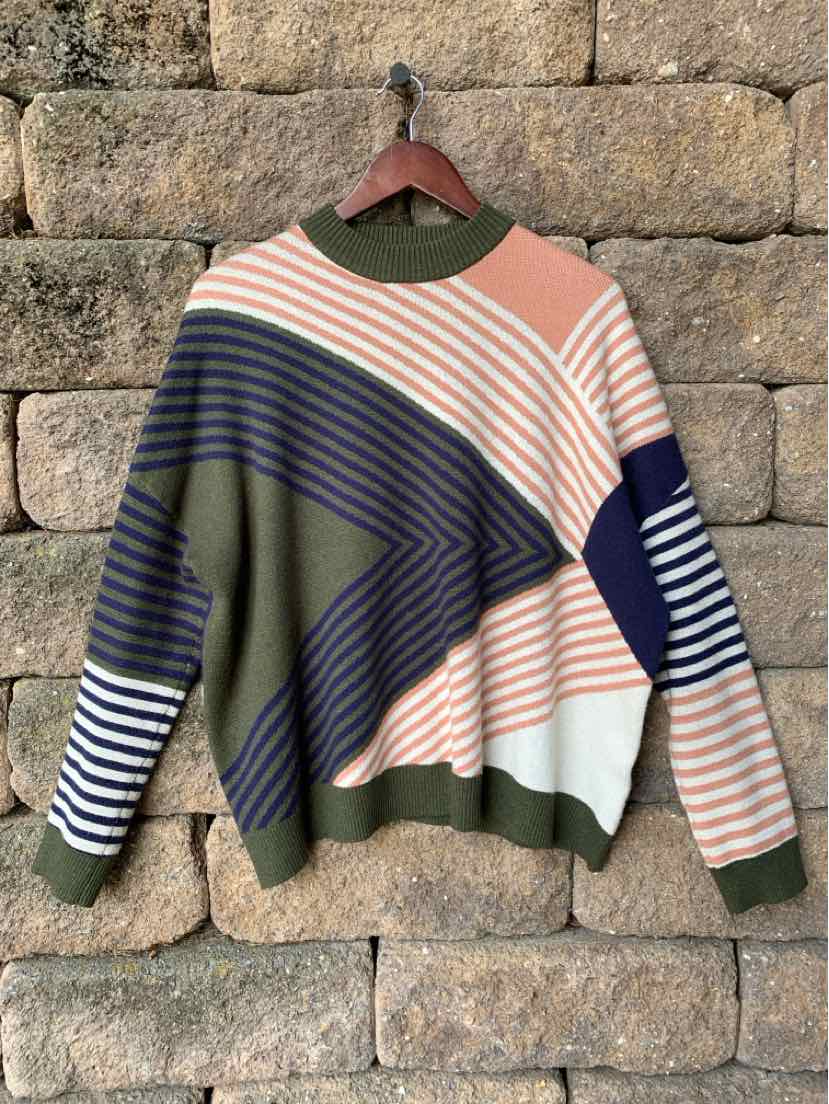 Multicolor geometric knit sweater with diagonal stripes in olive, navy, peach, white, and beige.