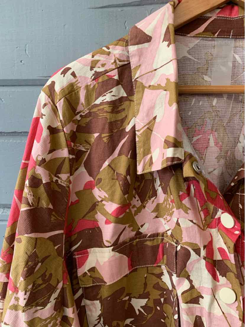 Loose-fit button-up shirt with pink, brown, and white abstract camo pattern.