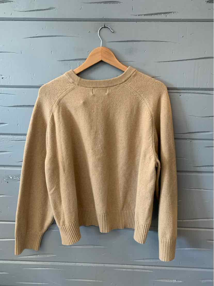 Tan knit sweater with crew neck and long sleeves in size XXL hanging on wooden hanger.