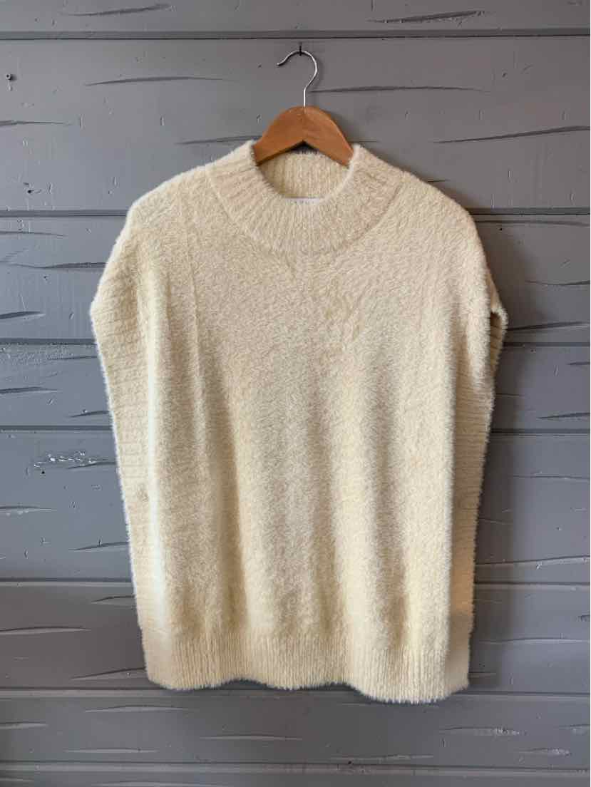 Cream-colored sleeveless knit sweater with crew neckline and soft textured fabric.