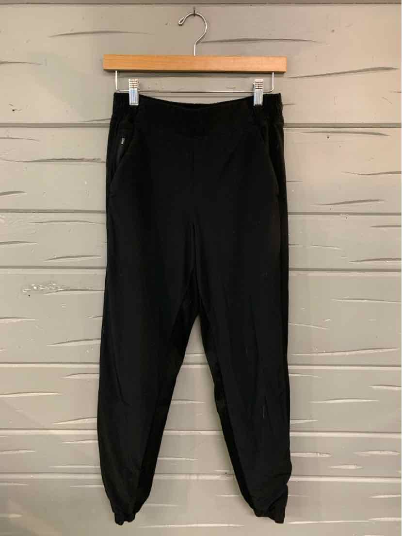 Black athletic jogger pants with elastic cuffs and zippered side pockets, size 4.