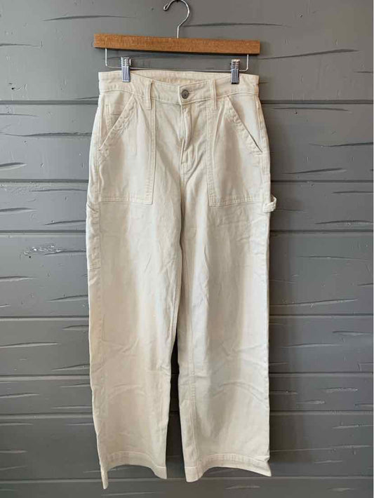 White high-waisted casual pants with straight legs, button and zipper front, and side pockets.