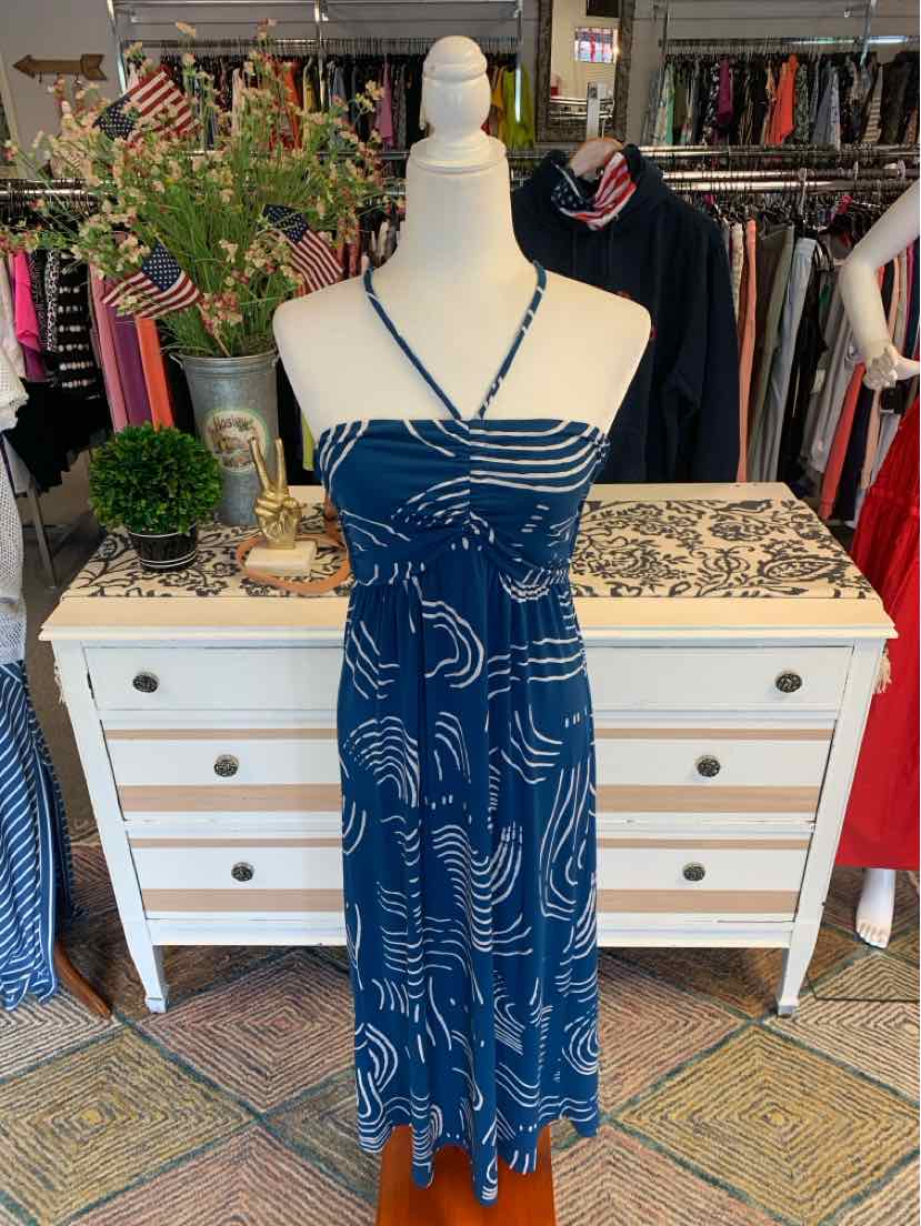 Blue patterned spaghetti strap dress with fitted bodice and flowy skirt on mannequin.