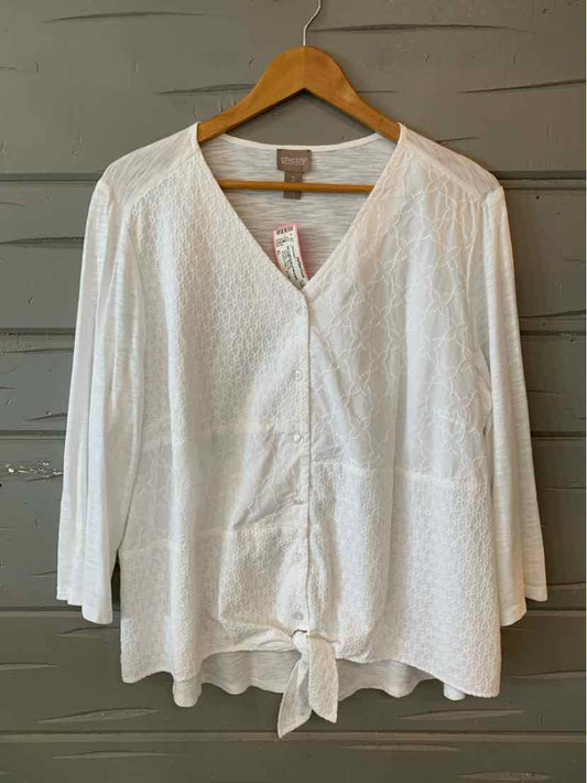 White long-sleeve blouse with V-neck, subtle textured pattern, and front tie detail.