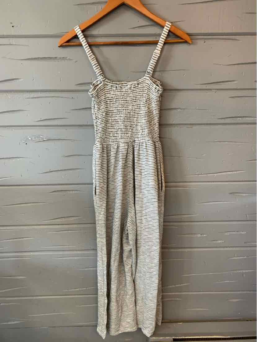 Light gray sleeveless jumpsuit with thin straps and a ruched bodice, featuring a striped texture and relaxed wide-leg pants.
