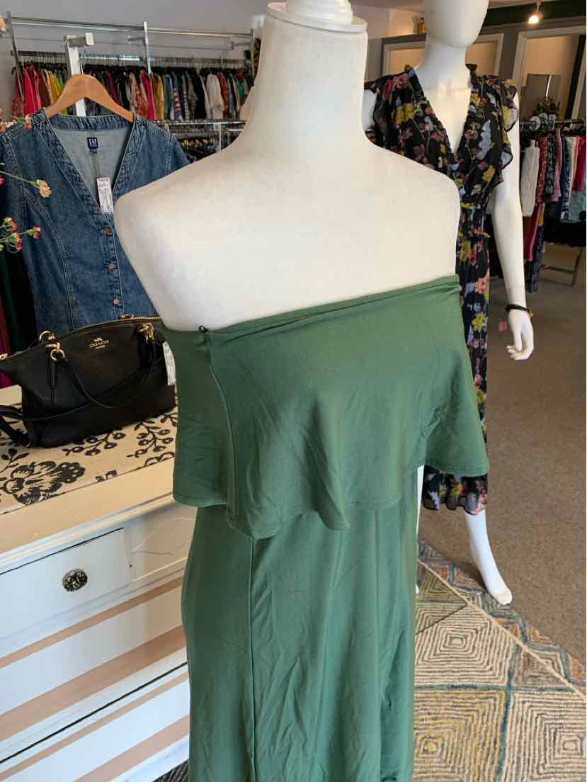 Off-shoulder solid green dress with ruffle detail at bust, fitted silhouette, lightweight fabric.