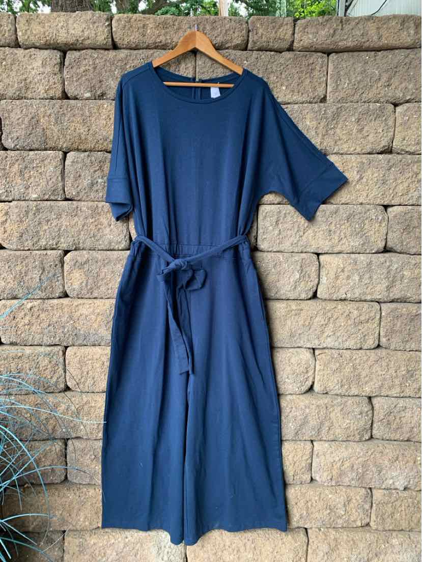 Navy blue short-sleeve lounge jumpsuit with round neckline and self-tie waist belt in soft fabric.