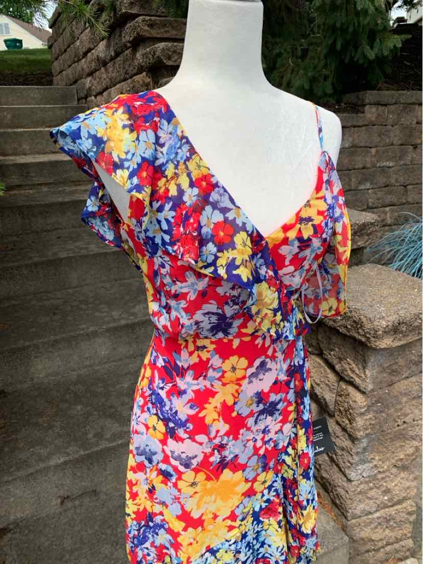 Floral wrap dress with ruffled cap sleeves in vibrant red, yellow, blue, and purple colors.