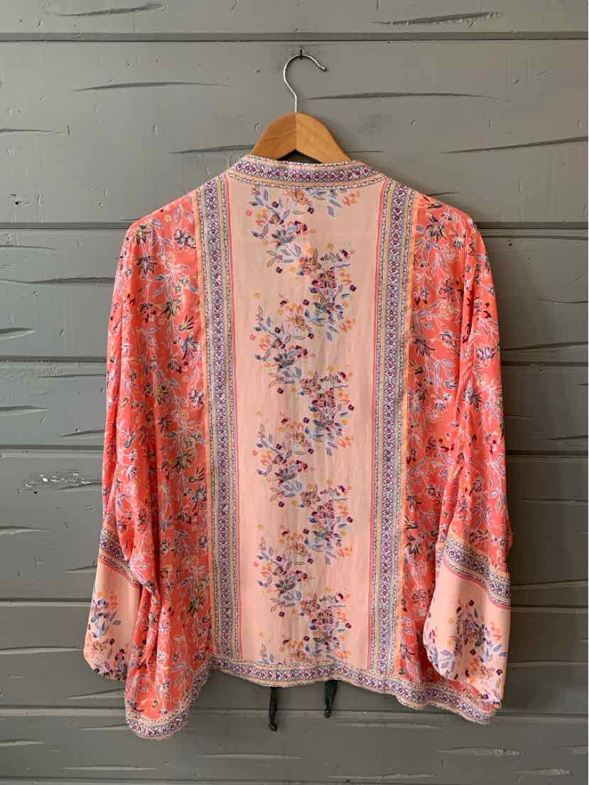 Pink floral long-sleeve blouse with vertical stripe detailing and loose fit.