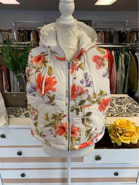 Cream floral print zip-up puffer vest with orange and green flower pattern on mannequin.
