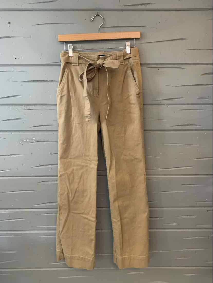 Tan high-waist trousers with a paperbag waist and fabric belt, straight-leg cut, lightweight material.