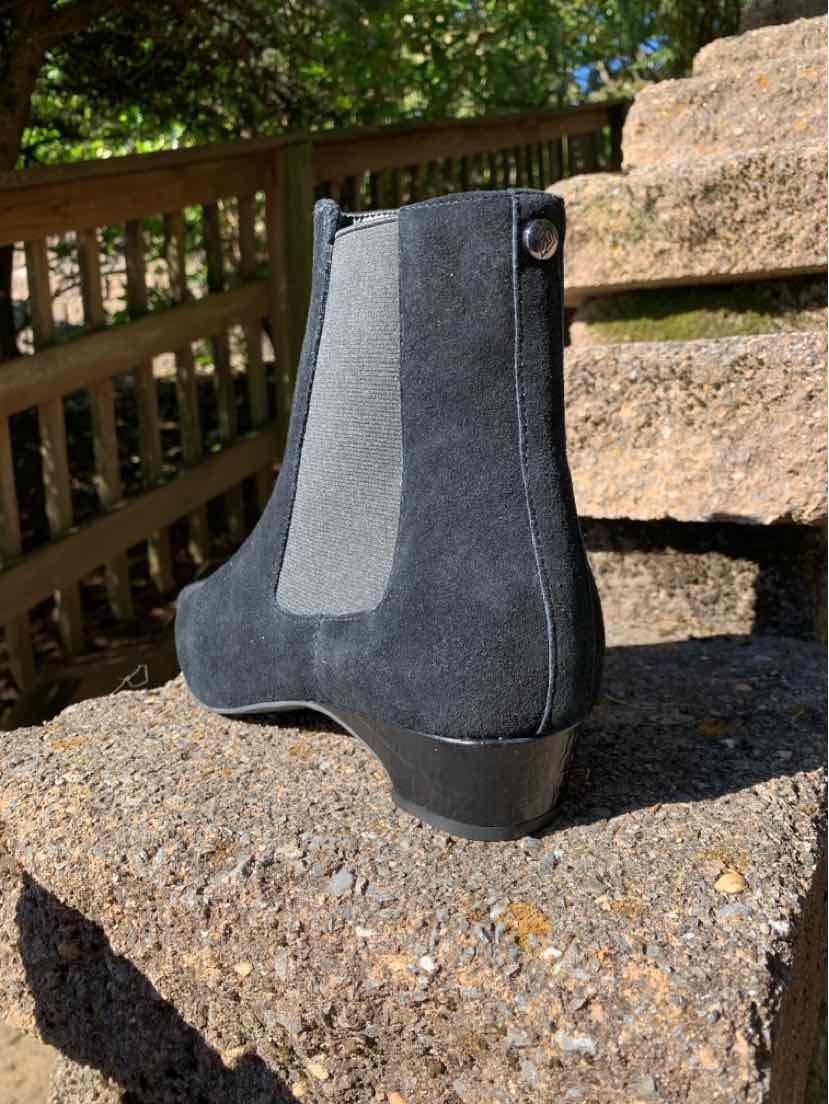 Black suede Donald Pliner ankle boot with a rounded toe, elastic side panel, and low stacked heel.