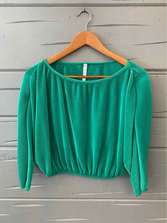 Green long-sleeve blouse with gathered waist and boat neckline on wooden hanger.