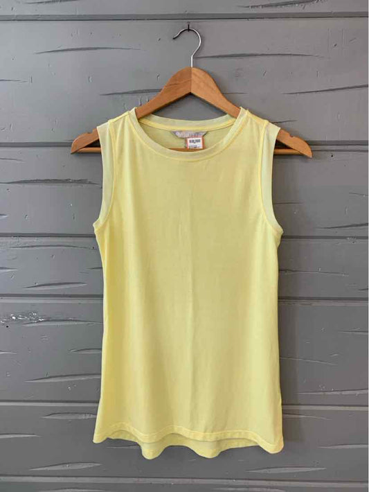 Light yellow sleeveless tank top with round neckline on wooden hanger against gray wood background.