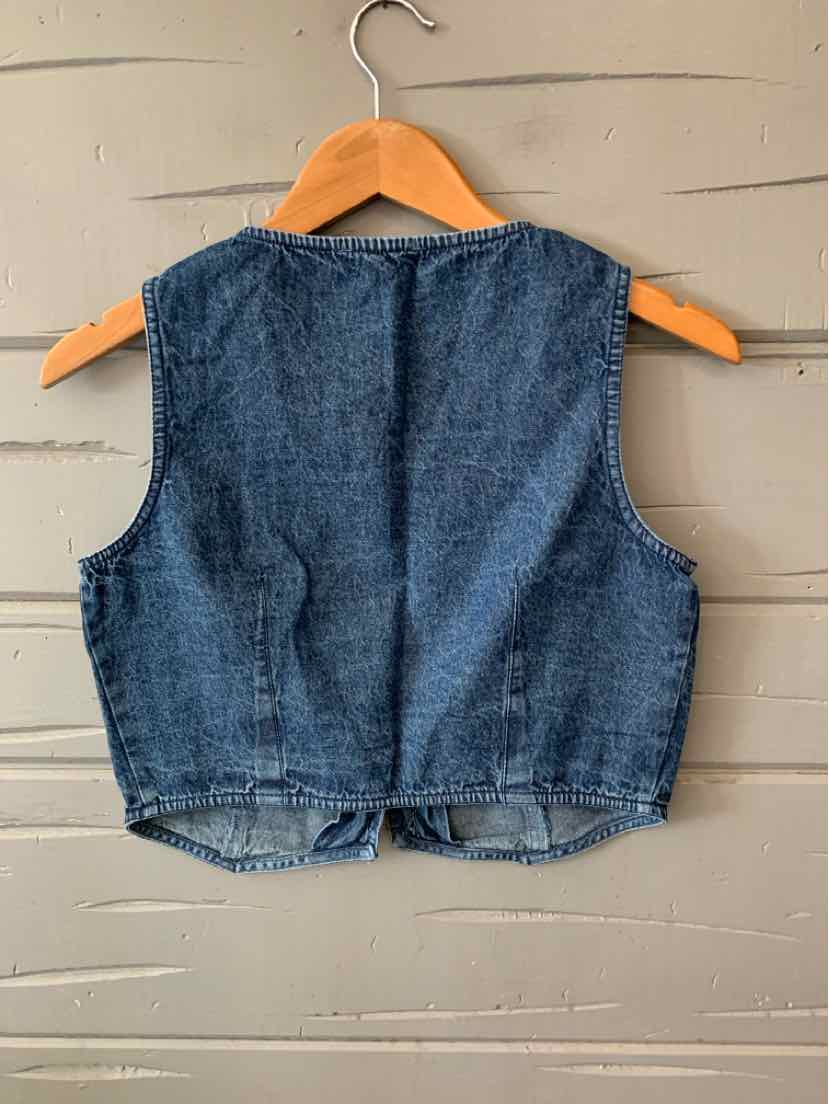 Blue chambray sleeveless cropped vest with a slightly textured fabric hanging on wood hanger.