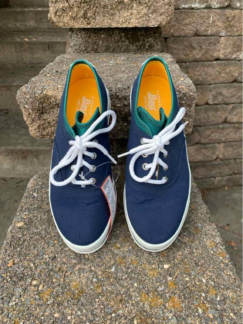Navy blue canvas sneakers with white laces and white rubber soles, size 7, casual style.