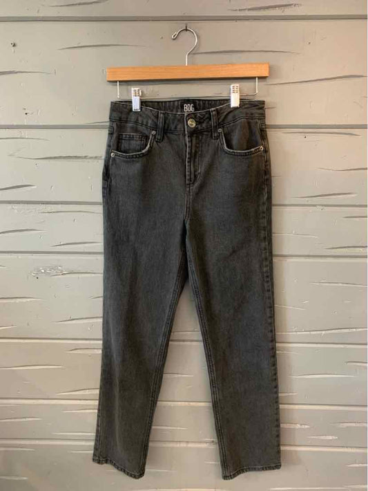High-waisted straight-leg gray denim jeans with front pockets and belt loops hanging on wooden hanger.