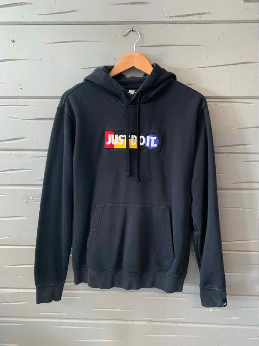 Black hoodie with front kangaroo pocket, drawstring hood, and colorful "JUST DO IT" logo across chest.