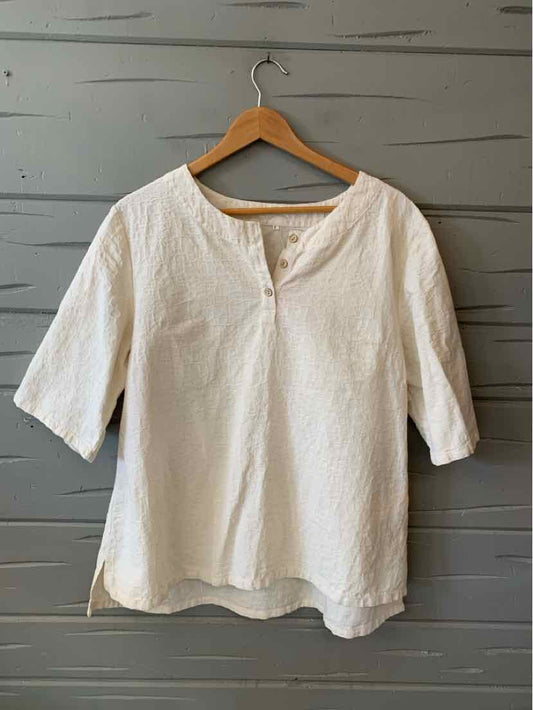 White linen blend blouse with three-quarter sleeves, round neckline, and front pocket, size large.