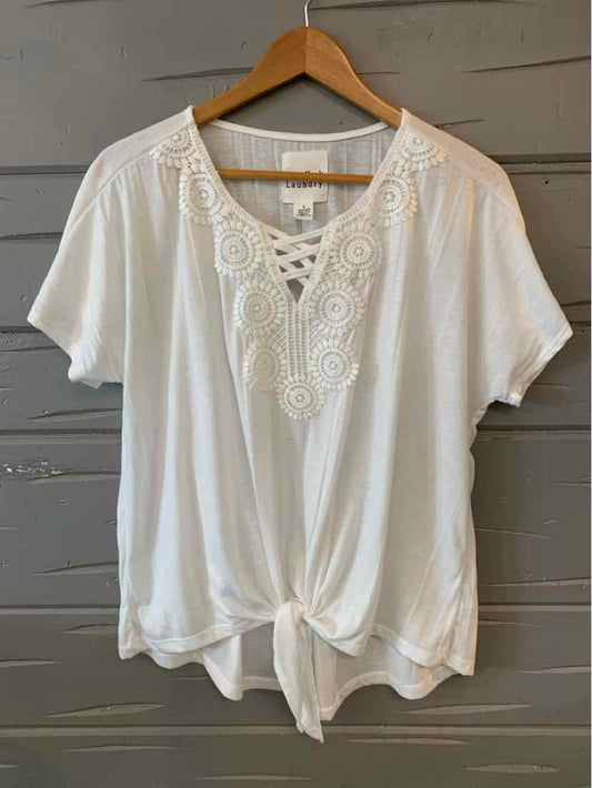 White short-sleeve blouse with lace V-neck detail and front tie hem on wooden hanger.