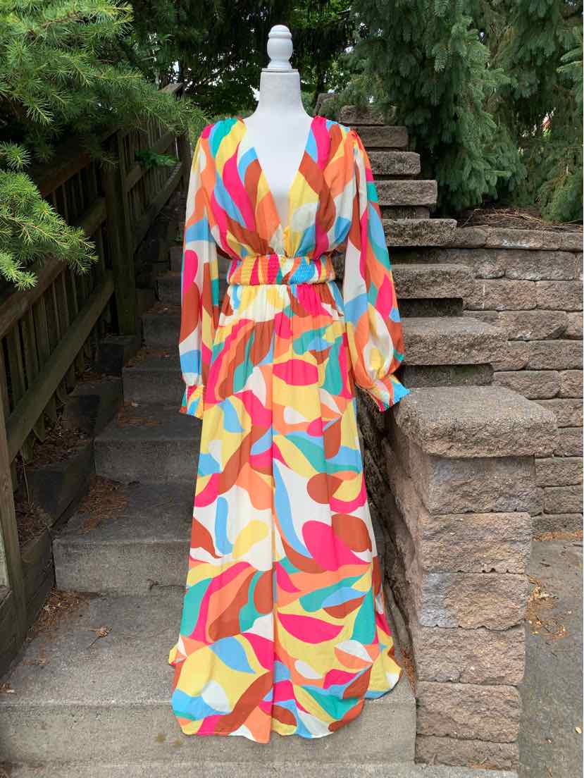 Colorful geometric maxi dress with long sleeves and a cinched waist belt.
