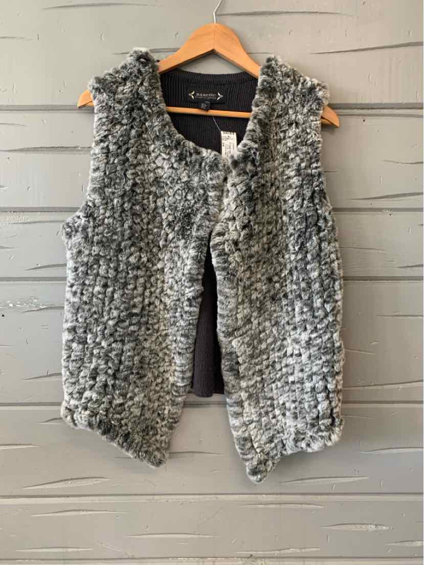 Gray faux fur sleeveless open-front vest with textured finish hanging on wooden hanger.