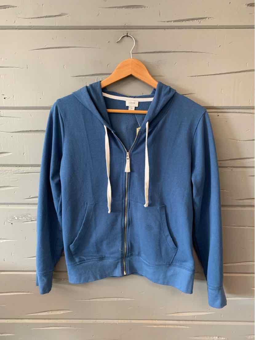 Blue zip-up hoodie with white drawstrings, long sleeves, and front pockets on wooden hanger.