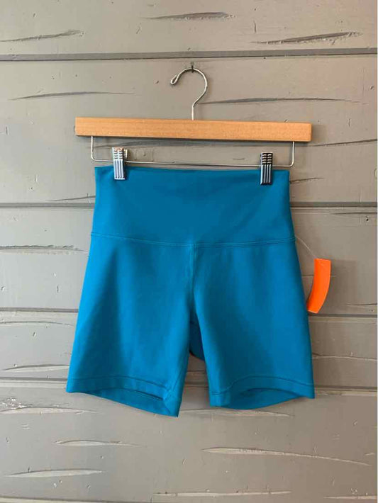 Blue high-waisted athletic shorts with a wide waistband and smooth finish, size 6.