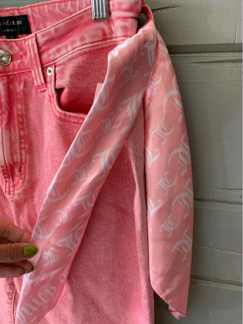 Pink denim jeans with a matching pink silk scarf featuring a white printed pattern.