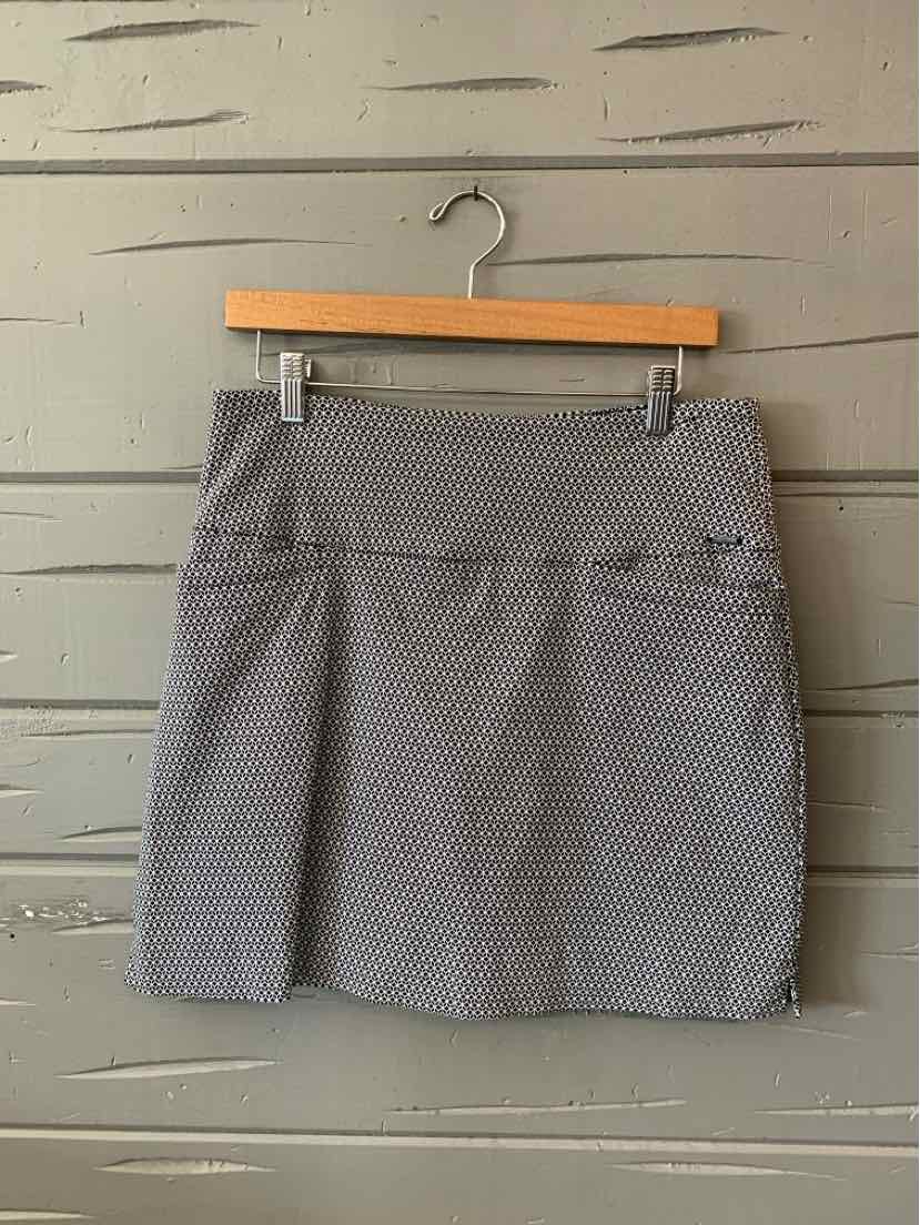 Gray patterned mid-length skort with wide waistband and lightweight fabric hanging on wooden hanger.