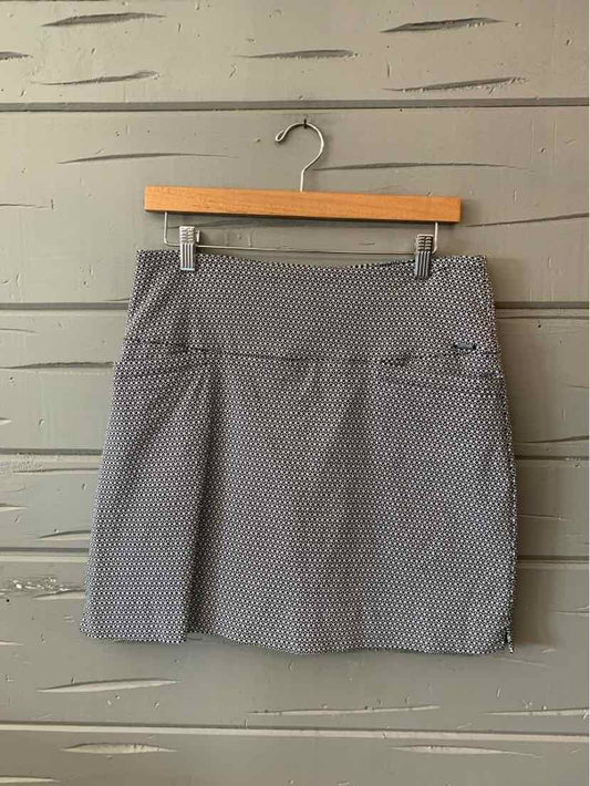 Gray patterned mid-length skort with wide waistband and lightweight fabric hanging on wooden hanger.