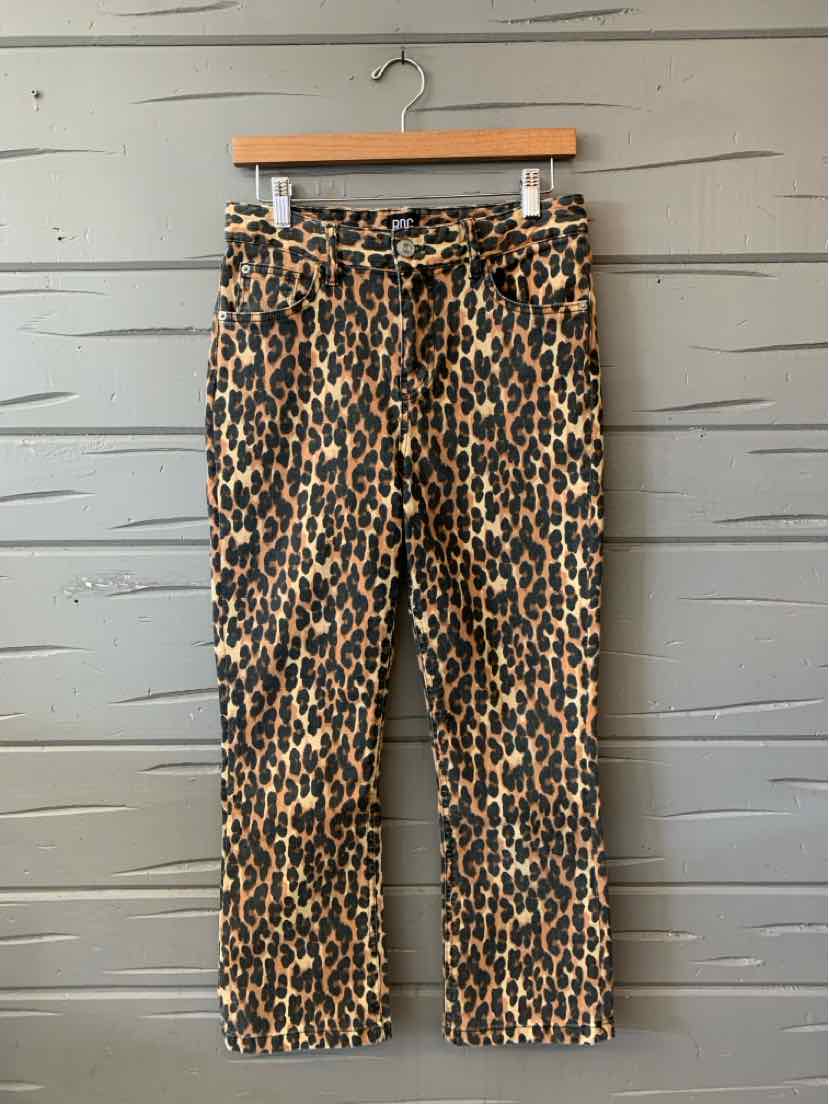 Tan leopard print cropped pants with a tied waist belt and straight legs.