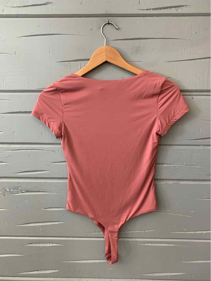Mauve short-sleeve fitted bodysuit with scoop neckline and snap closure at the bottom.