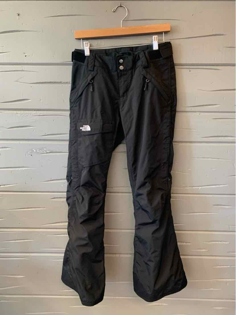 Black North Face women’s outdoor pants with a straight-leg fit, zip fly, and logo patch.