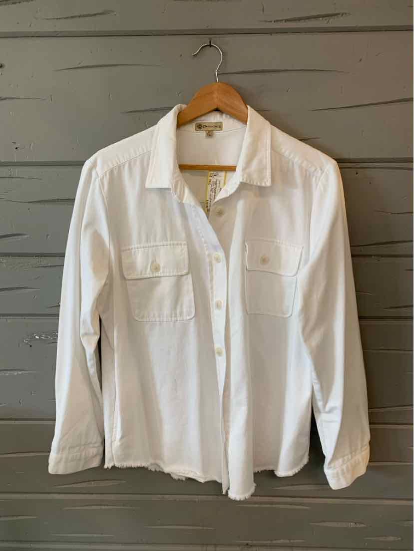 White long-sleeve button-up shirt with two front chest pockets and a classic collar hanging on wooden hanger.