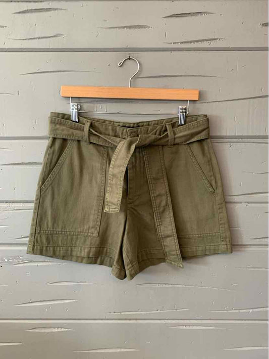 Olive green cotton shorts with tied fabric belt and front pockets, size 8.