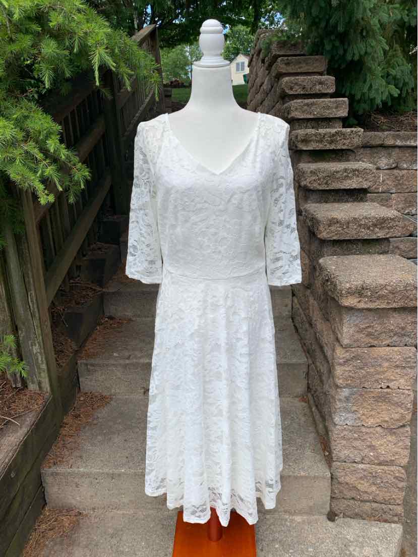 White lace dress with three-quarter sleeves, scoop neckline, and flared skirt in XL size.