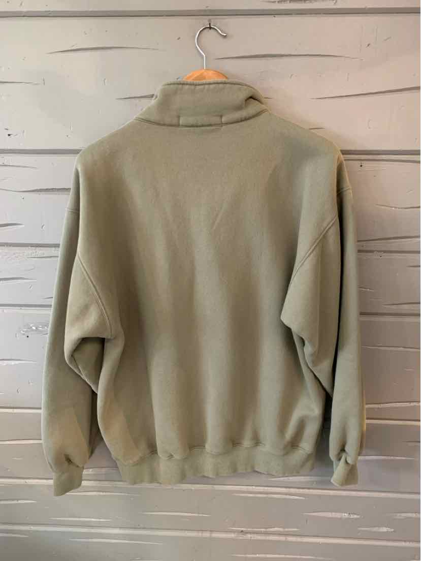Light gray-green pullover sweatshirt with long sleeves and a relaxed fit on a hanger.