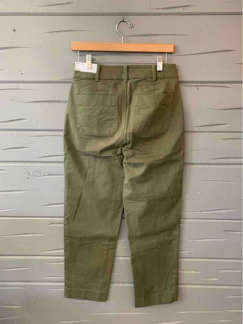 Olive green solid pants with a straight-leg cut, belt loops, and front pockets, hanging on a wooden hanger.