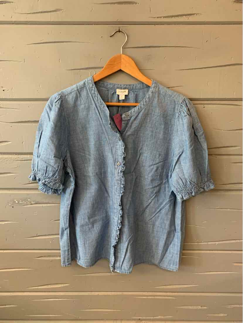 Light blue chambray blouse with short puff sleeves and buttons down the front.