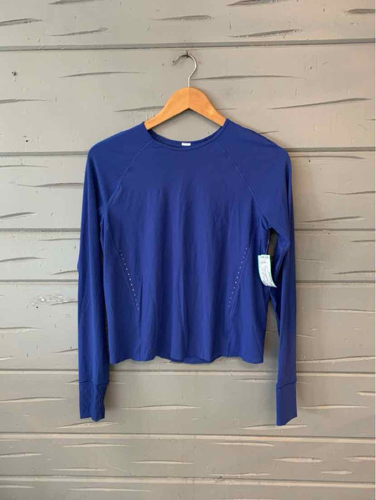 Long-sleeve solid blue crewneck top with thumbholes, made from lightweight fabric.