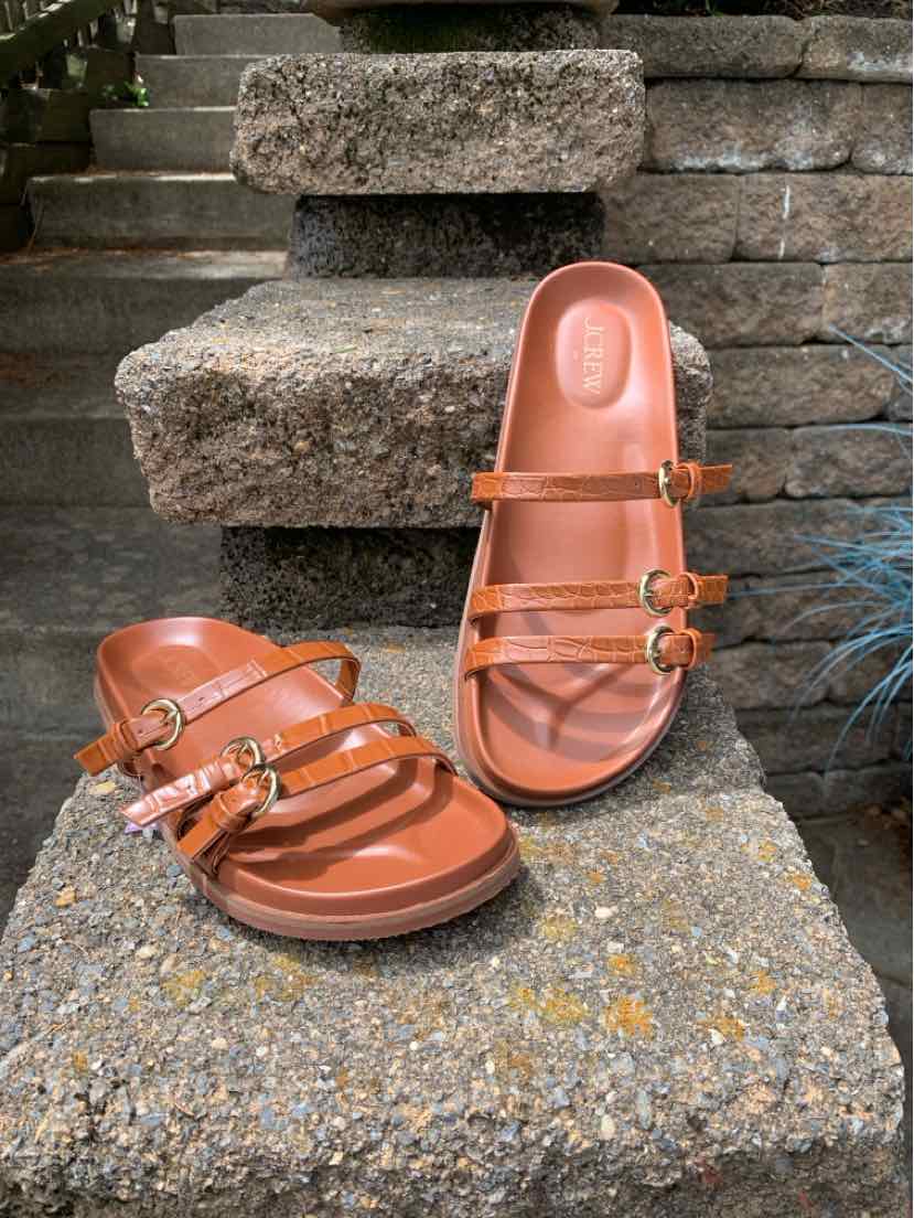 Women's brown leather sandals with double adjustable straps and flat sole, size 7.5.