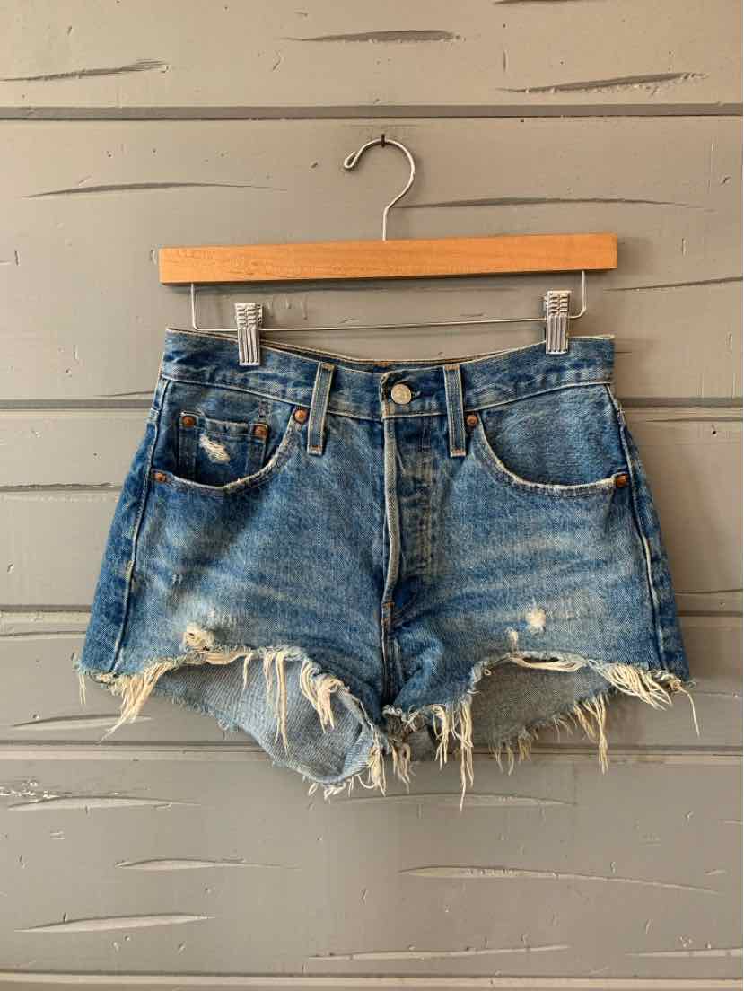 Blue denim Levi's shorts with frayed hems and distressed details, size 0.