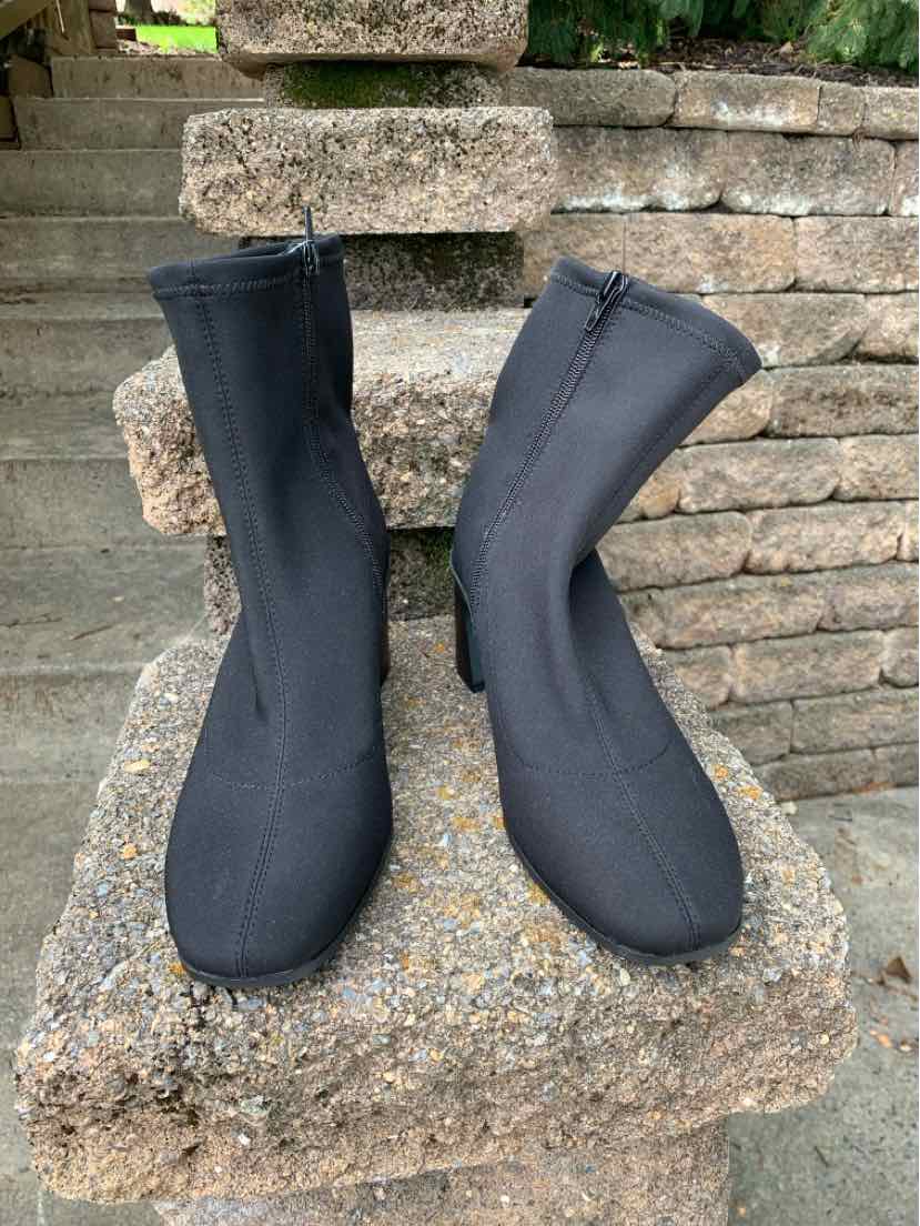 Black ankle boots with a sleek, stretchy fabric upper and rounded toe, size 8.5.
