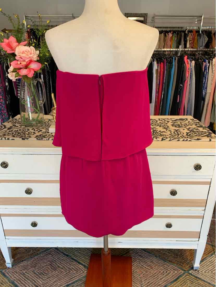 Fuchsia strapless mini dress with back zipper and straight hem on mannequin.