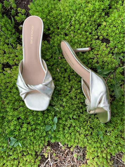 Metallic silver slip-on heels with square toes and ruched straps, size 8.5.