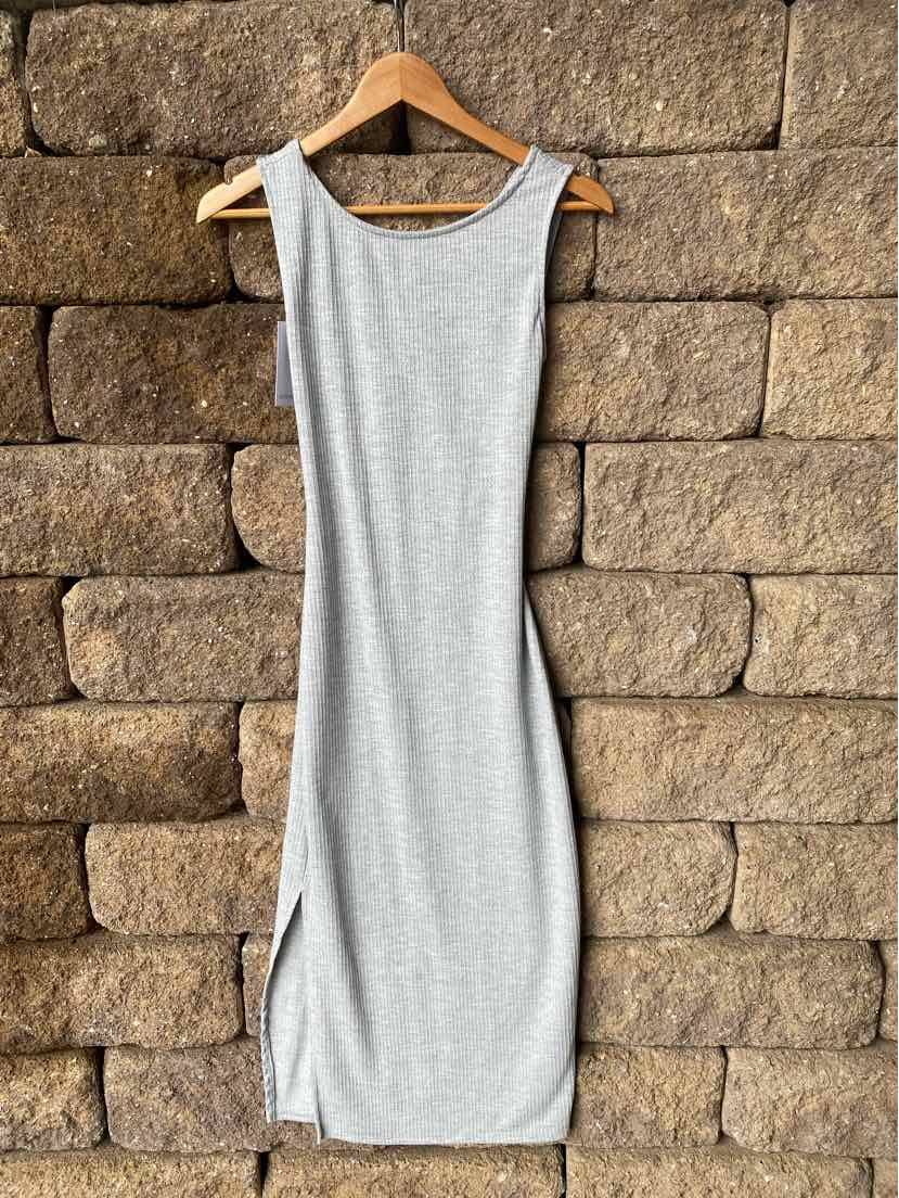 Light gray sleeveless midi dress with scoop neckline and side slit hanging on wooden hanger.