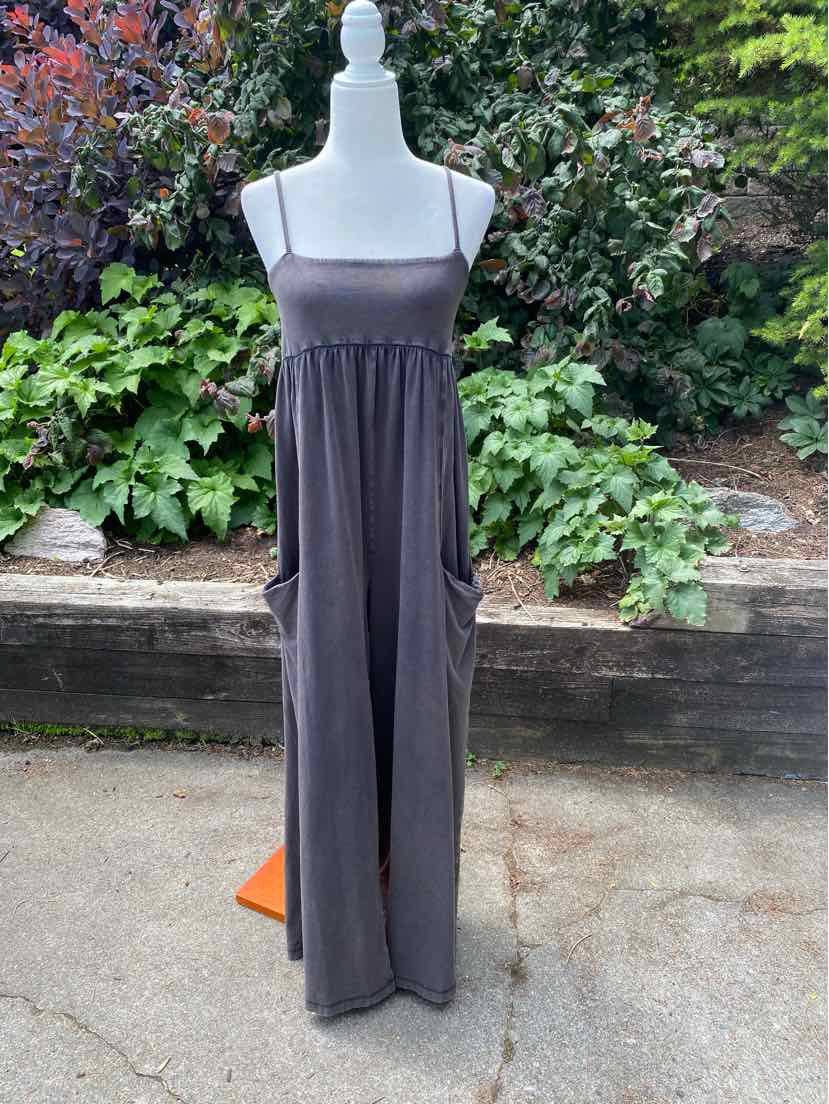 Gray sleeveless maxi dress with thin straps and gathered waist, featuring large front pockets.