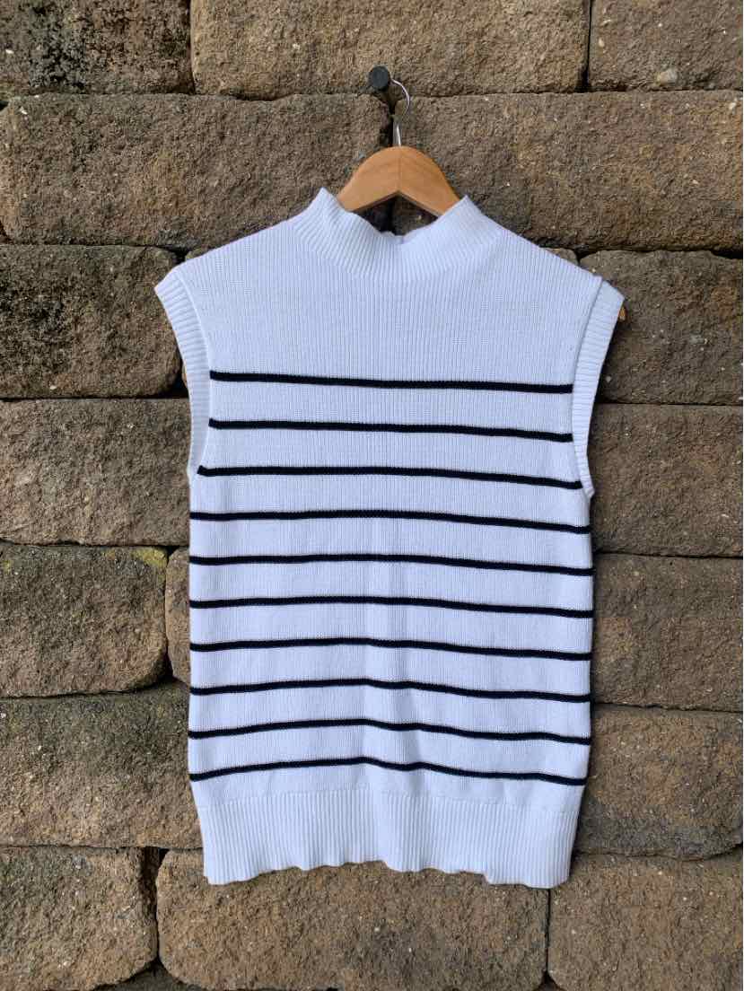 White sleeveless knit top with black horizontal stripes and a mock neck collar.